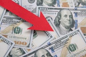 Inflation and rate falling concept with red arrow and one hundred American dollar bill