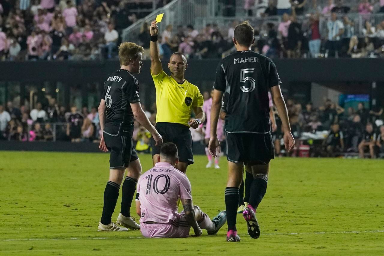 Nashville SC midfielder Dax McCarty (6) draws a yellow card after colliding with Inter Miami forward Lionel Messi (10) during the second half of an MLS soccer match, Wednesday, Aug. 30, 2023, in Fort Lauderdale, Fla. (AP Photo/Marta Lavandier)