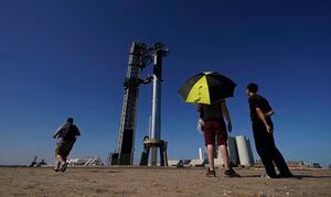 Onlookers watch as SpaceX's mega rocket Starship is prepared for its upcoming launch from Starbase in Boca Chica, Texas, Friday, Nov. 17, 2023. (AP Photo/Eric Gay)