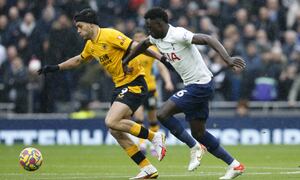Wolverhampton Wanderers' Raul Jimenez, left vies for the ball with Tottenham's Davinson Sanchez during the English Premier League soccer match between Tottenham Hotspur and Wolverhampton Wanderers and at White Hart Lane in London, Sunday, Feb. 13, 2022. (AP Photo/David Cliff)