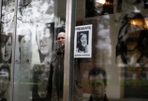 Esteban Herrera Simerman, 47, member of human rights organisation Abuelas de Plaza de Mayo (Grandmothers of Plaza de Mayo), who is looking for his half-brother born during Argentina's last dictatorship (1976-1983), holds a picture of his mother, Georgina Simerman, who was pregnant at the time of her disappearance, during an interview with Reuters inside the building of the former Navy Mechanics School, also known as ESMA, in Buenos Aires, Argentina July 24, 2023. REUTERS/Agustin Marcarian