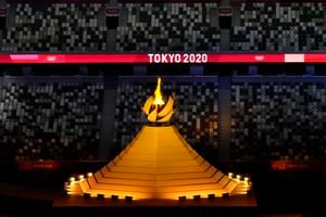 The Olympic flame burns during the opening ceremony in the Olympic Stadium at the 2020 Summer Olympics, Friday, July 23, 2021, in Tokyo, Japan. (AP Photo/Charlie Riedel)