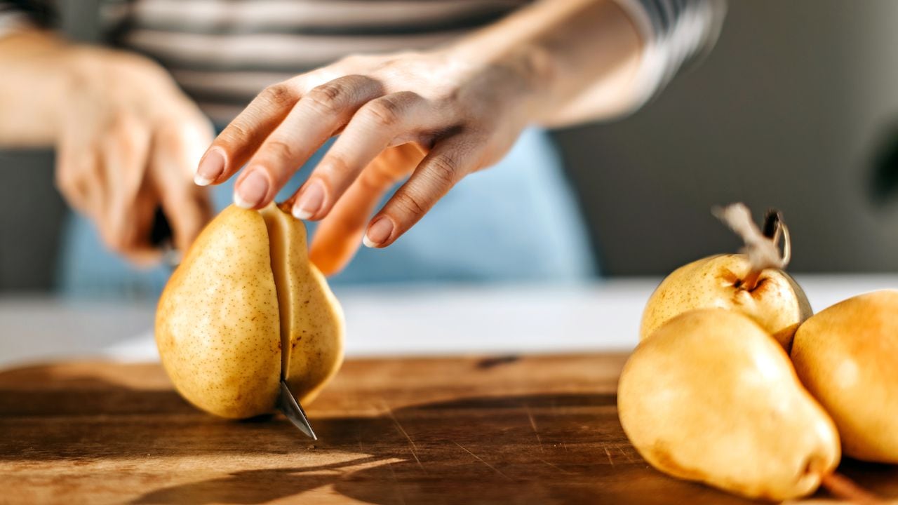 Woman cutting pear