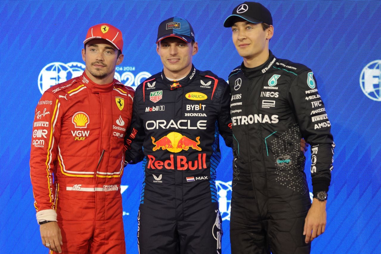 Red Bull Racing's Dutch driver Max Verstappen (C) poses along with Ferrari's Monegasque driver Charles Leclerc (L) and Mercedes' British driver George Russell after claiming pole position in the Bahrain Formula One Grand Prix at the Bahrain International Circuit in Sakhir on March 1, 2024. (Photo by Giuseppe CACACE / AFP)