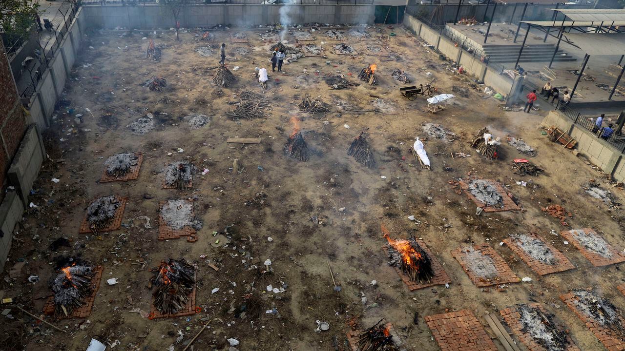 Multiple funeral pyres of victims of COVID-19 burn in a ground that has been converted into a crematorium for mass cremation, in New Delhi, India, Wednesday, April 21, 2021. India’s underfunded health system is tattering as the world’s worst coronavirus surge wears out the nation, which set a global record in daily infections for a second straight day with 332,730. (AP Photo)