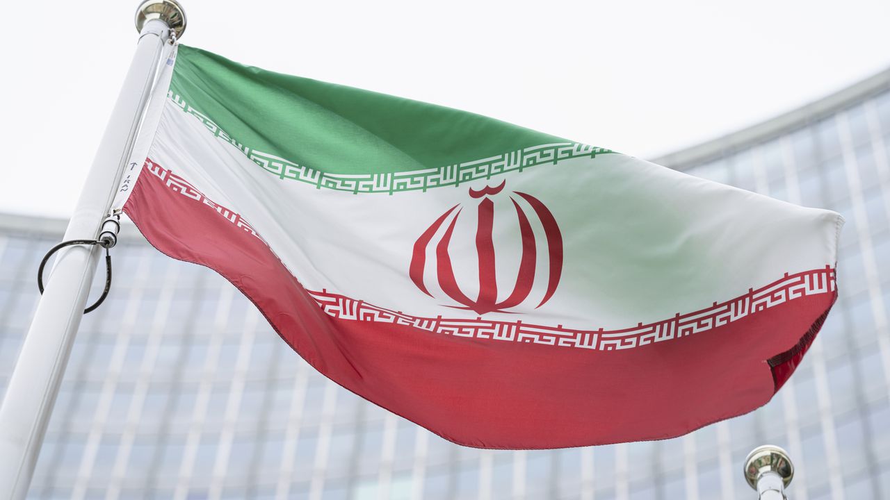 FILE - In this Monday, May 24, 2021 file photo, the flag of Iran waves in front of the the International Center building with the headquarters of the International Atomic Energy Agency, IAEA, in Vienna, Austria, Monday, May 24, 2021.  The United Nations’ International Atomic Energy Agency watchdog reported Monday May 31, 2021, it hasn't been able to access data important to monitoring Iran’s nuclear program since late February when the Islamic Republic started restricting international inspections of its facilities.  (AP Photo/Florian Schroetter, FILE)