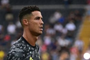 In this photograph taken on August 22, 2021, Juventus' Portuguese forward Cristiano Ronaldo looks on prior to the Italian Serie A football match between Udinese and Juventus at the Dacia Arena Stadium in Udine. - Cristiano Ronaldo will not train with Juventus on August 27, the Serie A giants confirmed to AFP, as rumours of an imminent move to Manchester City gather pace. Widespread media reports said that Ronaldo left Juve's Continassa training centre before the start of Friday's session. Sky Sport Italia reported that the five-time Ballon d'Or winner arrived in the morning to say goodbye to his teammates before leaving at around 10:45 am local time (0845 GMT). Asked by AFP if Ronaldo would be training with his Juve teammates, a club spokeswoman confirmed that he would not. (Photo by MIGUEL MEDINA / AFP)