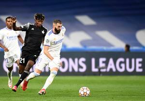 Real Madrid's Karim Benzema, right, duels for the ball with Sheriff's Edmund Addo during the Champions League group D soccer match between Real Madrid and Sheriff, Tiraspol at the Bernabeu stadium in Madrid, Spain, Tuesday, Sept. 28, 2021. (AP Photo/Jose Breton)