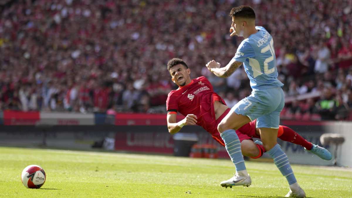 Manchester City's Joao Cancelo fights for the ball with Liverpool's Luis Diaz, left, during the English FA Cup semifinal soccer match between Manchester City and Liverpool at Wembley stadium in London, Saturday, April 16, 2022. (AP/Kirsty Wigglesworth)