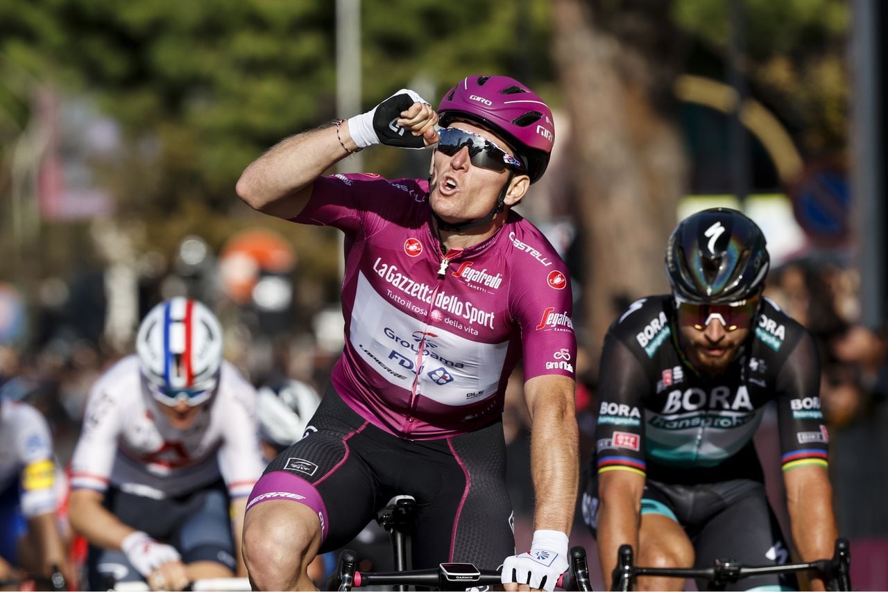 France's Arnaud Demare (Groupama - FDJ) (C) gestures as he crosses the line for victory in the seventh stage of the Giro d'Italia 2020 cycling race, a 143-kilometer route between Matera and Brindisi on October 9, 2020. (Photo by Luca Bettini / AFP)