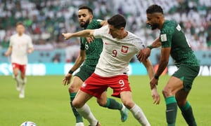 Soccer Football - FIFA World Cup Qatar 2022 - Group C - Poland v Saudi Arabia - Education City Stadium, Al Rayyan, Qatar - November 26, 2022 Poland's Robert Lewandowski in action with Saudi Arabia's Mohammed Al Burayk and Abdulelah Al-Amri REUTERS/Matthew Childs