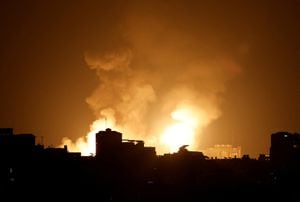 Smoke and flames rise into the sky after the Israeli military said in a statement that it has struck Islamic Jihad targets, in Gaza, May 9, 2023. REUTERS/Mohammed Salem