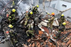 Bomberos trabajan en el lugar del accidente de una avioneta que cayó sobre casas en una zona residencial de Medellín, Colombia, el lunes 21 de noviembre de 2022. (AP Foto/Jaime Saldarriaga)