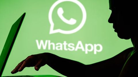 BRAZIL - 2024/03/27: In this photo illustration, the WhatsApp logo is seen in the background and a silhouette of a person using a notebook. (Photo Illustration by Rafael Henrique/SOPA Images/LightRocket via Getty Images)