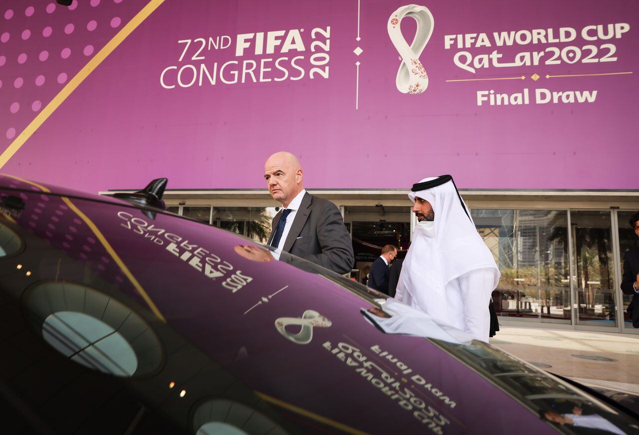 29 March 2022, Qatar, Doha: FIFA President Gianni Infantino (l) gets into his waiting vehicle after a tour of the Doha Exhibition & Convention Center (DECC) in the West Bay district. The DECC will host the Fifa Congress on March 31 and the group draw for the 2022 World Cup in Qatar on April 1. Photo: Christian Charisius/dpa (Photo by Christian Charisius/picture alliance via Getty Images)