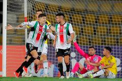 Palestino's midfielder Felipe Chamorro (L) celebrates after scoring his team's second goal during the Copa Libertadores group stage first leg football match between Chile's Palestino and Colombia's Millonarios at the Municipal Francisco Sanchez Rumoroso Stadium in Coquimbo, Chile, on April 25, 2024. (Photo by Javier TORRES / AFP)