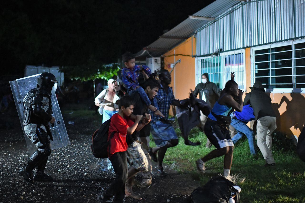 Agentes de migración mexicanos detienen a migrantes centroamericanos y haitianos que se dirigían en una caravana a Estados Unidos. Cientos de haitianos huyen del país caribeño debido a la profunda crisis humanitaria que padecen actualmente. (Photo by ISAAC GUZMAN / AFP)