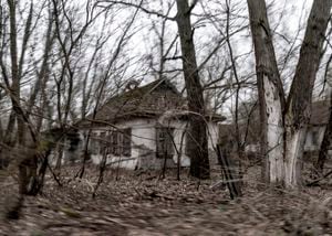 Abandoned country houses are seen at the Chernobyl exclusion zone, Ukraine, Tuesday, April 13, 2021. The Ukrainian authorities are calling for the exclusion zone of objects to be included in the UNESCO World Heritage List, since the object is a unique place "of interest to all mankind". The Ministry of Culture of Ukraine has already taken steps to recognize the zone as a monument, which will attract more funding and tourists. (AP Photo/Evgeniy Maloletka)