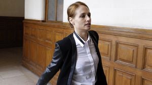 Eloise Bouton, a former member of the Femen movement, arrives at court for her trial, on October 15, 2014 in Paris, as she faces charges of indecent exposure after toplessly miming an abortion in a Paris church in December 2013. AFP PHOTO/FRANCOIS GUILLOT (Photo by FRANCOIS GUILLOT / AFP)