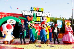 Mario, center, and other characters participate in the opening ceremony of "Super Nintendo World," the new attraction based on Nintendo Co.'s "Super Mario Bros." game series, at Universal Studios Japan (USJ) in Osaka, western Japan, Thursday, March 18, 2021. The opening was postponed twice due to the influence of the coronavirus. (Kyodo News via AP)