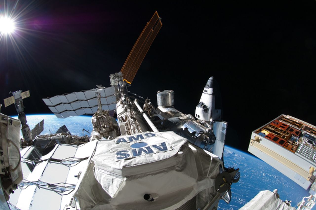 This picture, photographed during the spacewalk conducted on July 12, 2011, shows the International Space Station with space shuttle Atlantis docked at right. In the center foreground is the Alpha Magnetic Spectrometer experiment installed
during the STS-134 mission.