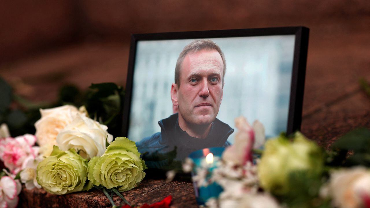 Se colocan flores y una vela junto a un retrato del líder de la oposición rusa Alexei Navalny tras la muerte de Navalny mientras la gente se reúne cerca de la embajada rusa, en París, Francia