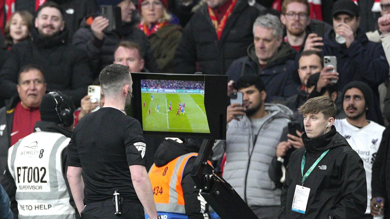 Referee Chris Kavanagh pauses the match and asks for the VAR to check on a possible goal during the English League Cup final soccer match between Chelsea and Liverpool at Wembley Stadium in London, Sunday, Feb. 25, 2024. (AP Photo/Dave Shopland)