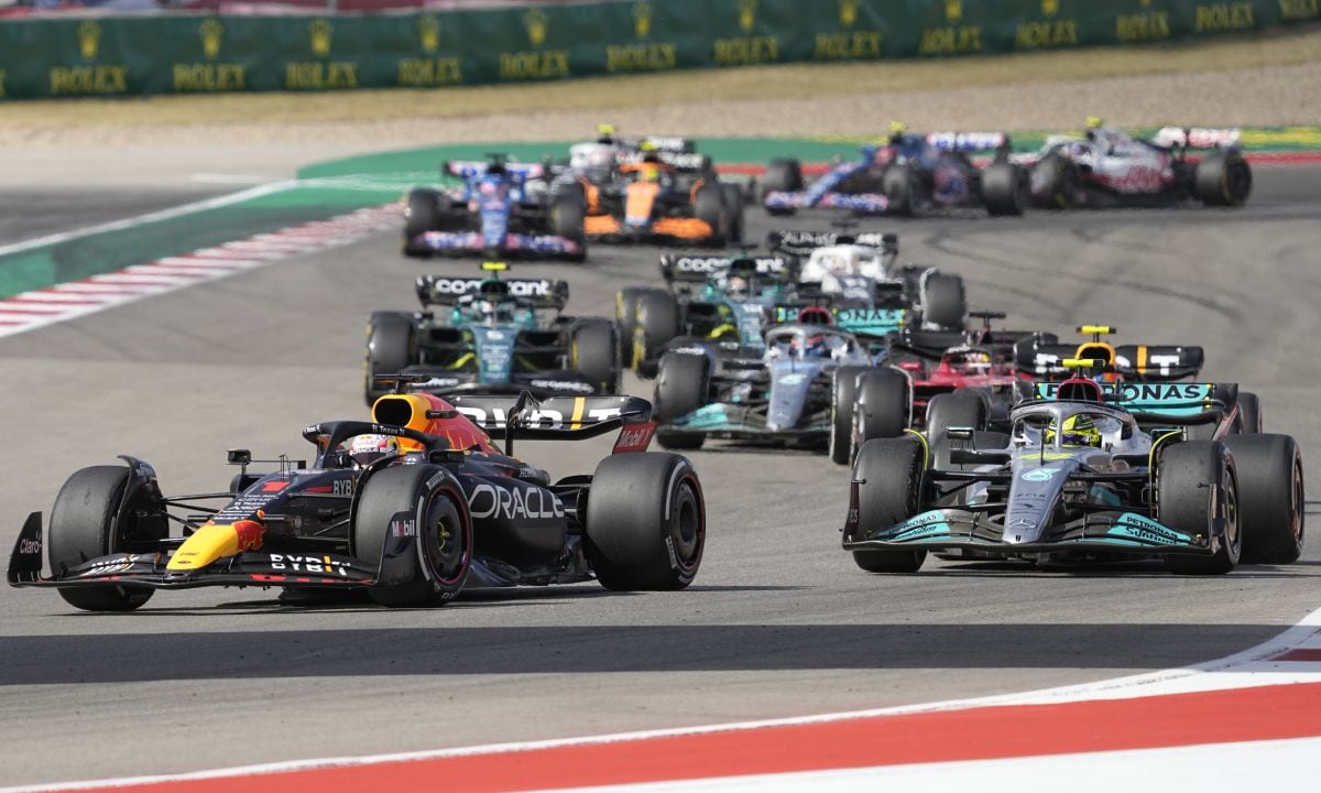 Red Bull driver Max Verstappen, of the Netherlands, front left, leads Mercedes driver Lewis Hamilton, of Britain, right, and the rest of the field during the Formula One U.S. Grand Prix auto race at the Circuit of the Americas, Sunday, Oct. 23, 2022, in Austin, Texas. (AP/Charlie Neibergall)