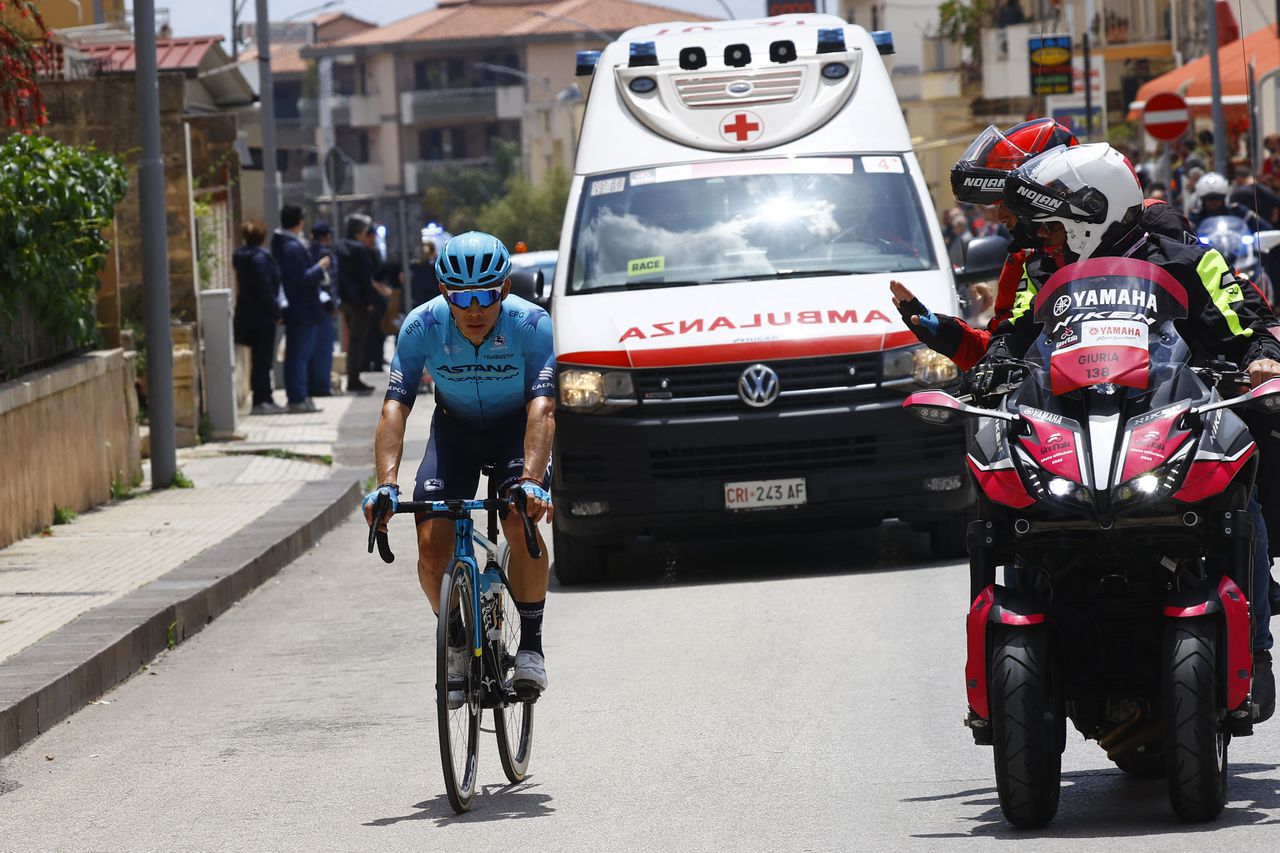 Team Astana's Colombian rider Miguel Angel Lopez rides by an Italian Red Cross ambulance in the first kilometers of the 4th stage of the Giro d'Italia 2022 cycling race, 172 kilometers between Avola and Etna-Nicolosi, Sicily, on May 10, 2022. (Photo by Luca Bettini / AFP)