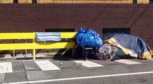 Homeless person's sidewalk shelter covered with tarps.