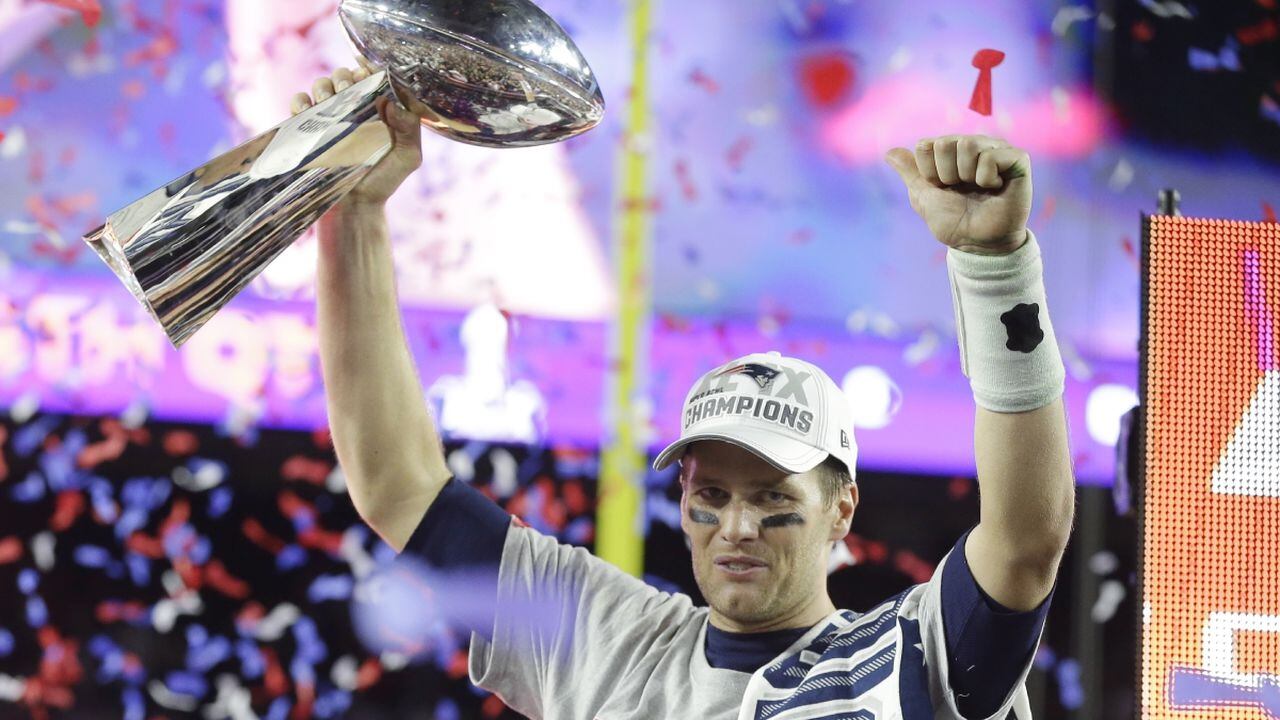 FILE - New England Patriots quarterback Tom Brady celebrates with the Vince Lombardi Trophy after the NFL Super Bowl XLIX football game against the Seattle Seahawks Sunday, Feb. 1, 2015, in Glendale, Ariz. The Patriots won 28-24. Tom Brady has retired after winning seven Super Bowls and setting numerous passing records in an unprecedented 22-year-career. He made the announcement, Tuesday, Feb. 1, 2022, in a long post on Instagram. (AP/Michael Conroy, File)