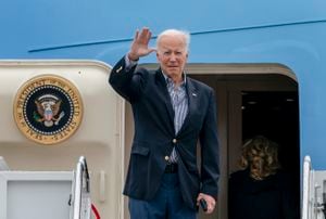President Joe Biden waves before boarding Air Force One for a trip to Florida to visit areas impacted by Hurricane Ian, Wednesday, Oct. 5, 2022, at Andrews Air Force Base, Md. (AP Photo/Gemunu Amarasinghe)