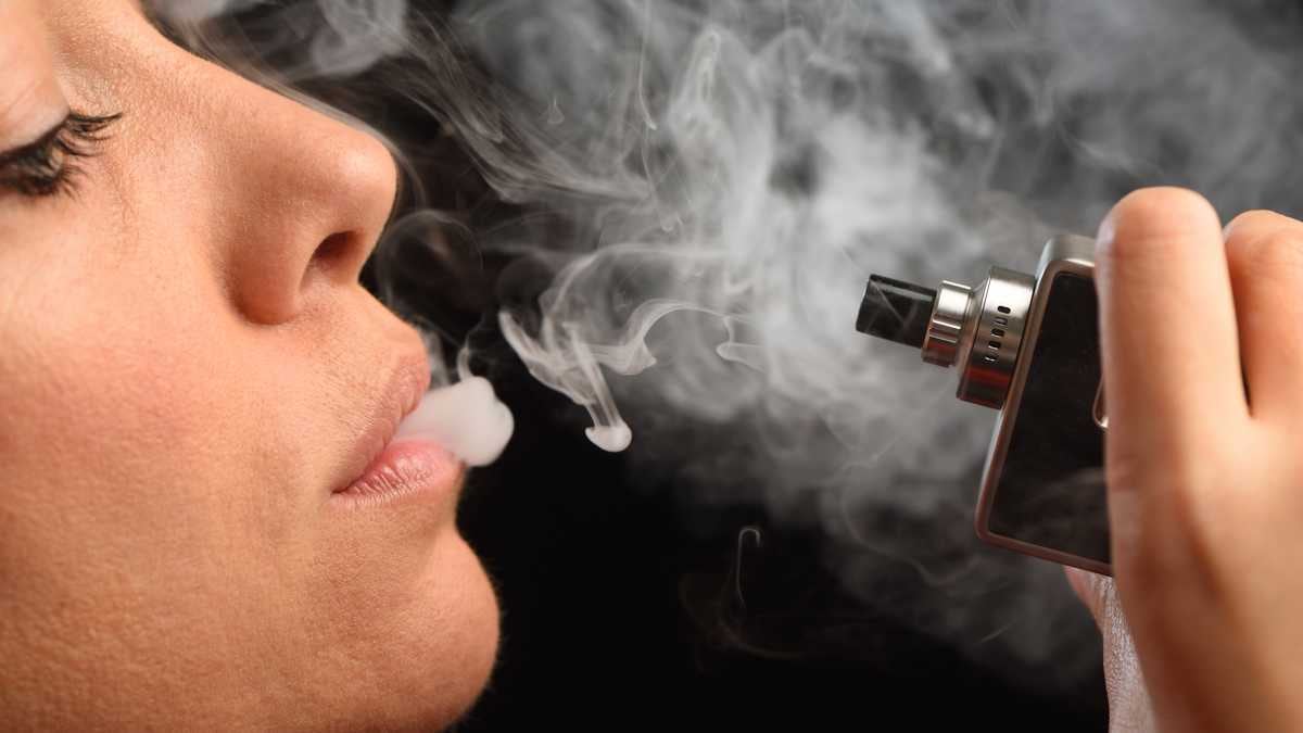 Close up shot of using an electronic cigarette. Vaping concept.