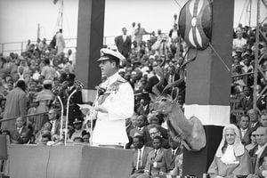 FILE - In this Dec. 12, 1963 file photo, Britain's Prince Philip delivers an address before handing over to Jomo Kenyatta, Prime Minister of Kenya, during the ceremony of Independence at Uhuru Stadium on  in Nairobi. The ceremony brought to an end 68 years of British rule in Kenya.  Buckingham Palace officials say Prince Philip, the husband of Queen Elizabeth II, has died, it was announced on Friday, April 9, 2021. He was 99. Philip spent a month in hospital earlier this year before being released on March 16 to return to Windsor Castle. Philip, also known as the Duke of Edinburgh, married Elizabeth in 1947 and was the longest-serving consort in British history. (AP Photo/Dennis Royle, File)