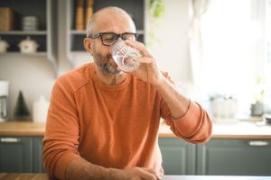 Mature adult man drinking water