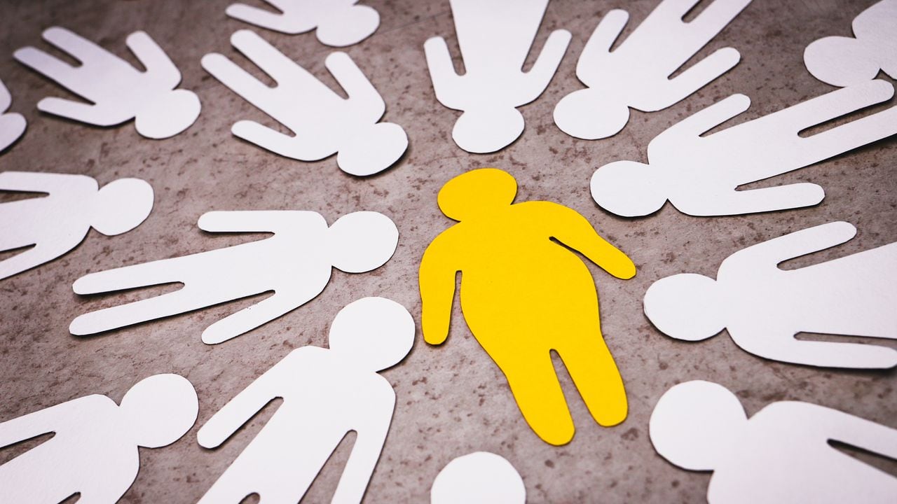 Yellow silhouette of fat man in the center on brown background. White figures of people around. Bullying and aggression of people who are overweight.