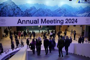 Participants walk through congress centre of the Annual Meeting of World Economic Forum in Davos, Switzerland, Wednesday, Jan. 17, 2024. The annual meeting of the World Economic Forum is taking place in Davos from Jan. 15 until Jan. 19, 2024.(AP Photo/Markus Schreiber)
