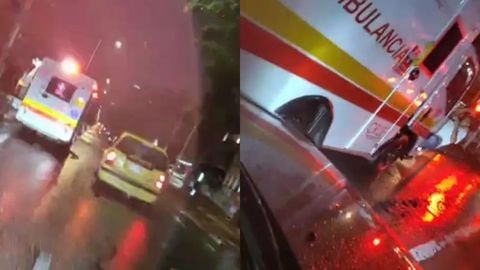 Un conductor se colgó al espejo de una ambulancia en Bogotá para reclamarle a la tripulación por el choque a su vehículo.