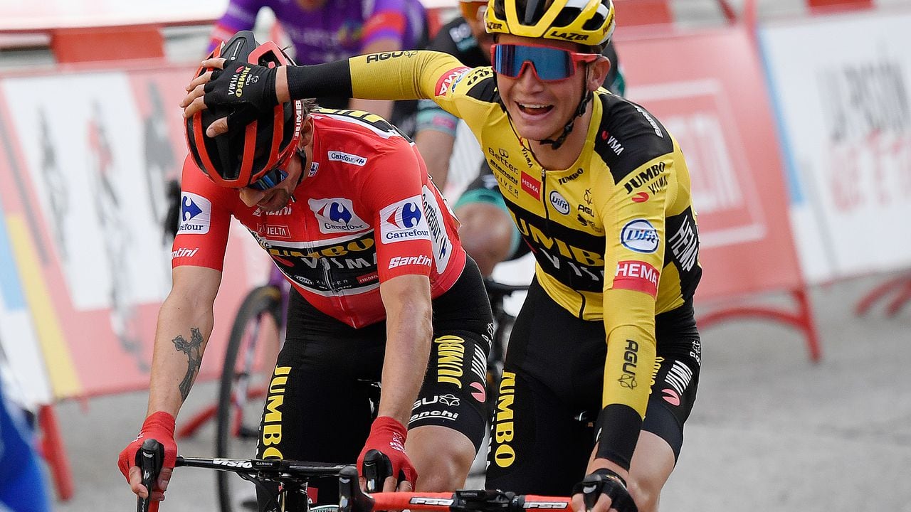 Team Jumbo's Slovenian rider Primoz Roglic (L) is congratluated for winning the 2020 La Vuelta at the end of the 18th and final stage of the 2020 La Vuelta cycling tour of Spain, a 124,2-km race from the Zarzuela racecourse to central Madrid, on November 8, 2020. (Photo by OSCAR DEL POZO / AFP)