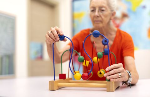 Old Woman make exercise why she is protected Alzheimer's disease