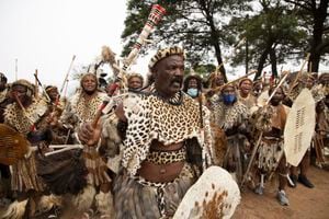 Amabutho (Zulu regiments) make their way to the mortuary to receive the body of King Goodwill Zwelithini from in Nongoma, KwaZulu Natal on March 17, 2021. - King Goodwill Zwelithini died on March 12, 2021 in the eastern city of Durban, aged 72, after weeks of treatment for a diabetes-related illness.
His remains have been taken back to his birthplace, the small southeastern town of Nongoma in Kwa-Zulu Natal province, where he will be laid to rest after midnight.
The intimate ceremony, to be conducted behind closed doors at the KwaKhethomthandayo royal residence, is referred to as a "planting" rather than a burial. (Photo by Phill Magakoe / AFP)