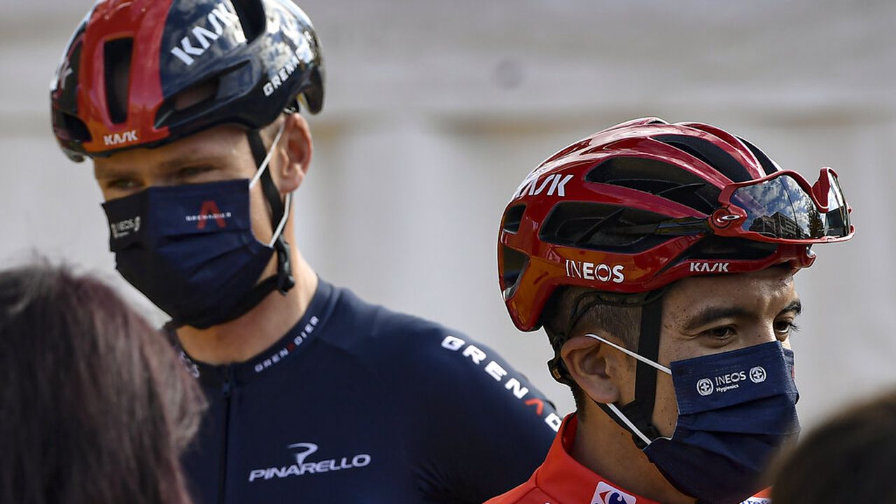 Ineos's Richard Carapaz, red shirt leader of La Vuelta, right, talks to the media close to Chris Froome during checkpoint control before starting the eighth stage of La Vuelta between Logrono and Alto de Moncalvillo, in Logrono, northern Spain, Wednesday, Oct. 28, 2020. (AP Photo/Alvaro Barrientos)