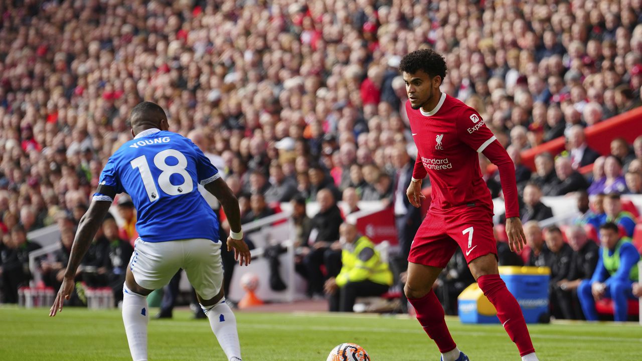 Liverpool's Luis Diaz, right, in action against Everton's Ashley Young during the English Premier League soccer match between Liverpool and Everton, at Anfield in Liverpool, England, Saturday, Oct. 21, 2023. (AP Photo/Jon Super)