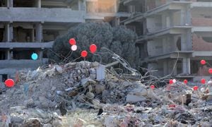 HATAY, TURKIYE - FEBRUARY 18: Red, blue and pink balloons are seen attached to the rubble of the collapsed building after 7.7 and 7.6 magnitude earthquakes hit Kahramanmaras, Turkiye on February 18, 2023. On Feb. 06, a strong 7.7 earthquake, centered in the Pazarcik district, jolted Kahramanmaras and strongly shook several provinces, including Gaziantep, Sanliurfa, Diyarbakir, Adana, Adiyaman, Malatya, Osmaniye, Hatay, Kilis, and Elazig. Later, at 1.24 p.m. (1024GMT), a 7.6 magnitude quake centered in Kahramanmaras' Elbistan district struck the region. (Photo by Erhan Sevenler/Anadolu Agency via Getty Images)
