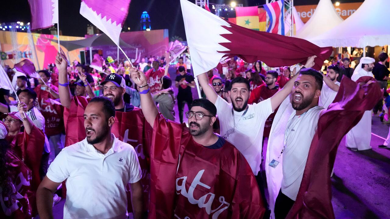 Qatar soccer fans celebrate as they wait for the World Cup, group A soccer match between Qatar and Ecuador at Hayya Fan Zone, in Lusail, outside of Doha, Qatar, Sunday, Nov. 20, 2022. (AP Photo/Lee Jin-man)