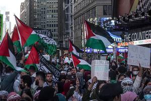 Palestinian supporters march with flags, signs and chant in protest, Friday, Oct. 13, 2023, in New York, as the Israel-Hamas war continues. (AP Photo/Bebeto Matthews)
