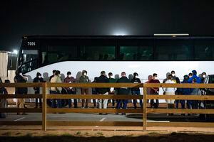 Migrant children and teenagers from the southern border of the United State are processed after entering the site of a temporary holding facility Sunday, March 14, 2021, south of Midland, Texas. (Odessa American/Eli Hartman)/Odessa American via AP)