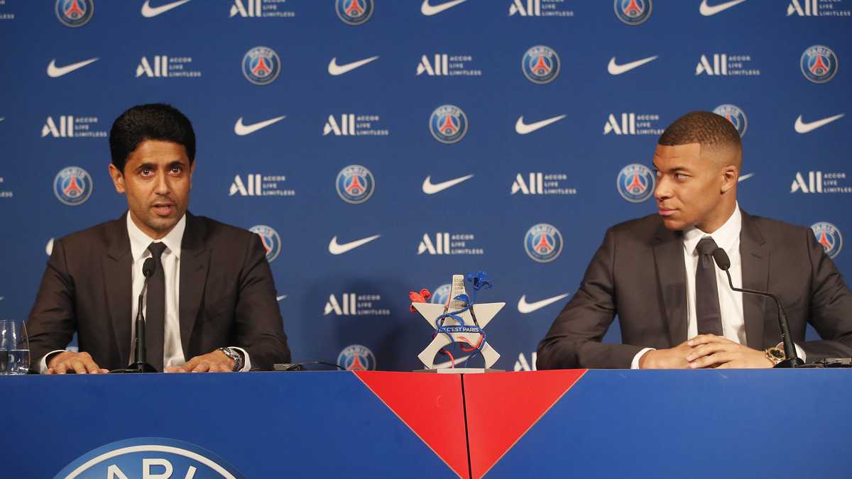PSG striker Kylian Mbappe, right, and PSG president Nasser Al-Al-Khelaifi attend a press conference Monday, May 23, 2022 at the Paris des Princes stadium in Paris. Kylian Mbappé's decision to reject Real Madrid and commit to Paris Saint-Germain for three more seasons marks the start of a large rebuilding project at the French league champion. (AP Photo/Michel Spingler)