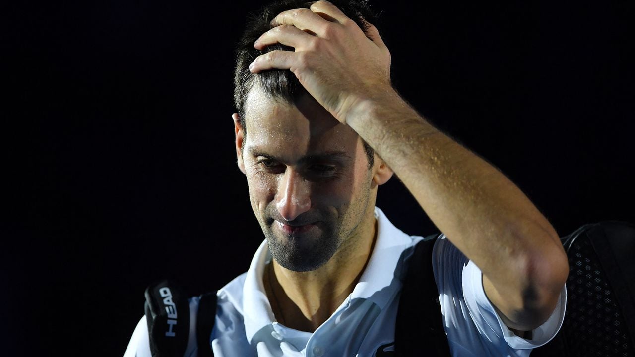 Serbia's Novak Djokovic reacts as he leaves the court after losing his semi-final match of the ATP Finals against Germany's Alexander Zverev at the Pala Alpitour venue in Turin on November 20, 2021. (Photo by Marco BERTORELLO / AFP)