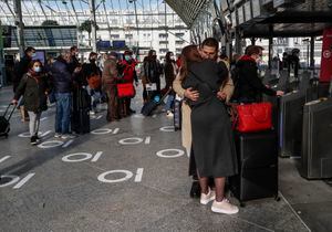 A couple kissing goodbye as passengers board a train at the Gare de Lyon train station in Paris, Friday, March 19, 2021. France's has ordered yesterday a partial lockdown for Paris and several other regions that takes effect on Friday night. (AP Photo/Michel Euler)